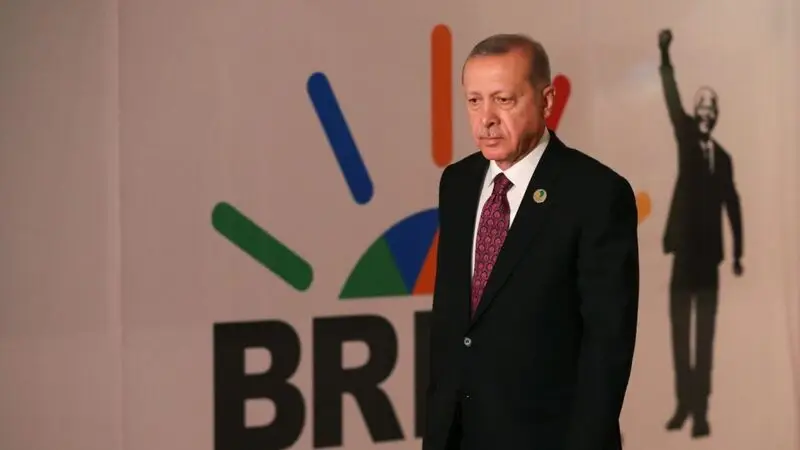 Turkey's Erdogan in front of a BRICS poster