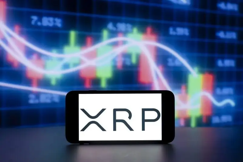 xrp logo on phone with charts background