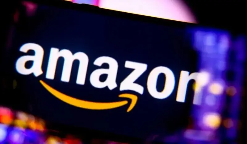 Amazon logo on dark background with company's signature smile arrow