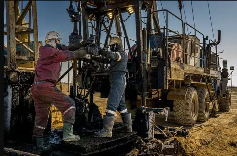 Kazakhstan oil production facility with workers