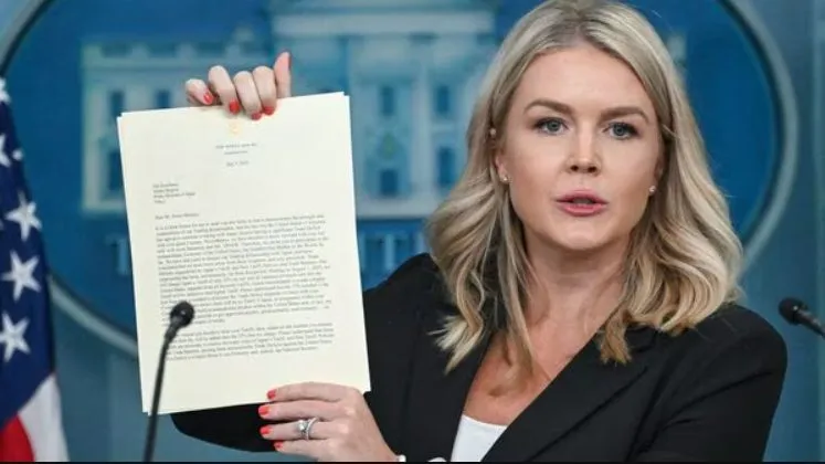 Karoline Leavitt holding trade letter