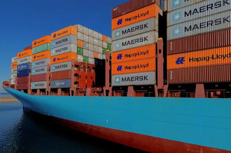 Large container ship with Maersk and Hapag-Lloyd containers at port
