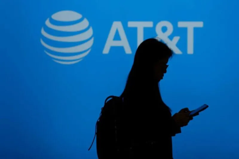 AT&T logo with person using mobile phone