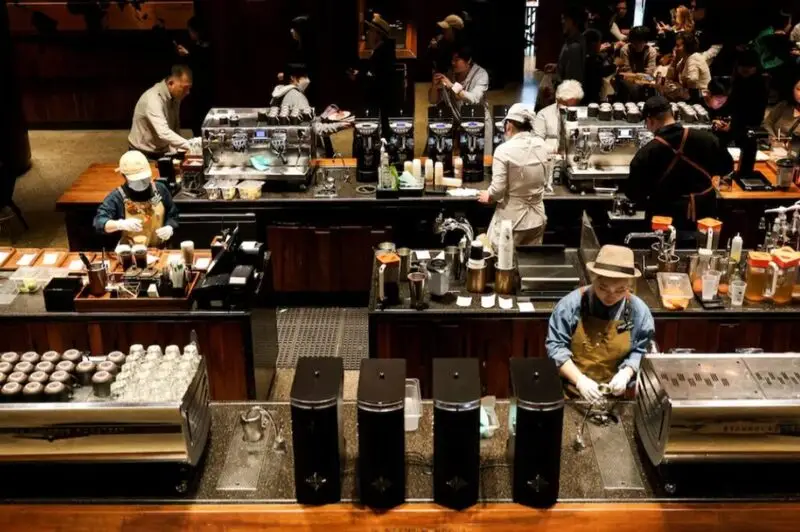 Busy Starbucks location in China with baristas serving customers