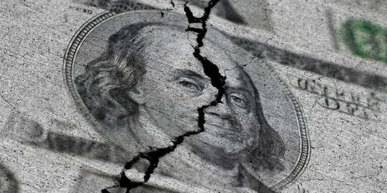 Cracked US dollar bill symbolizing dollar collapse