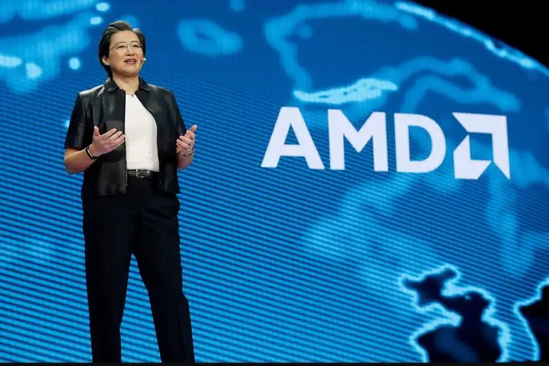 Lisa Su speaking at AMD event with blue company logo