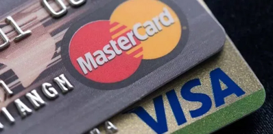 Visa, Mastercard Race to Tame $253B Crypto Threat